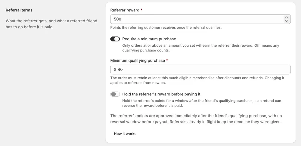 The referral terms: a referrer reward in points, a minimum qualifying purchase, and a switch to hold the reward before paying it.